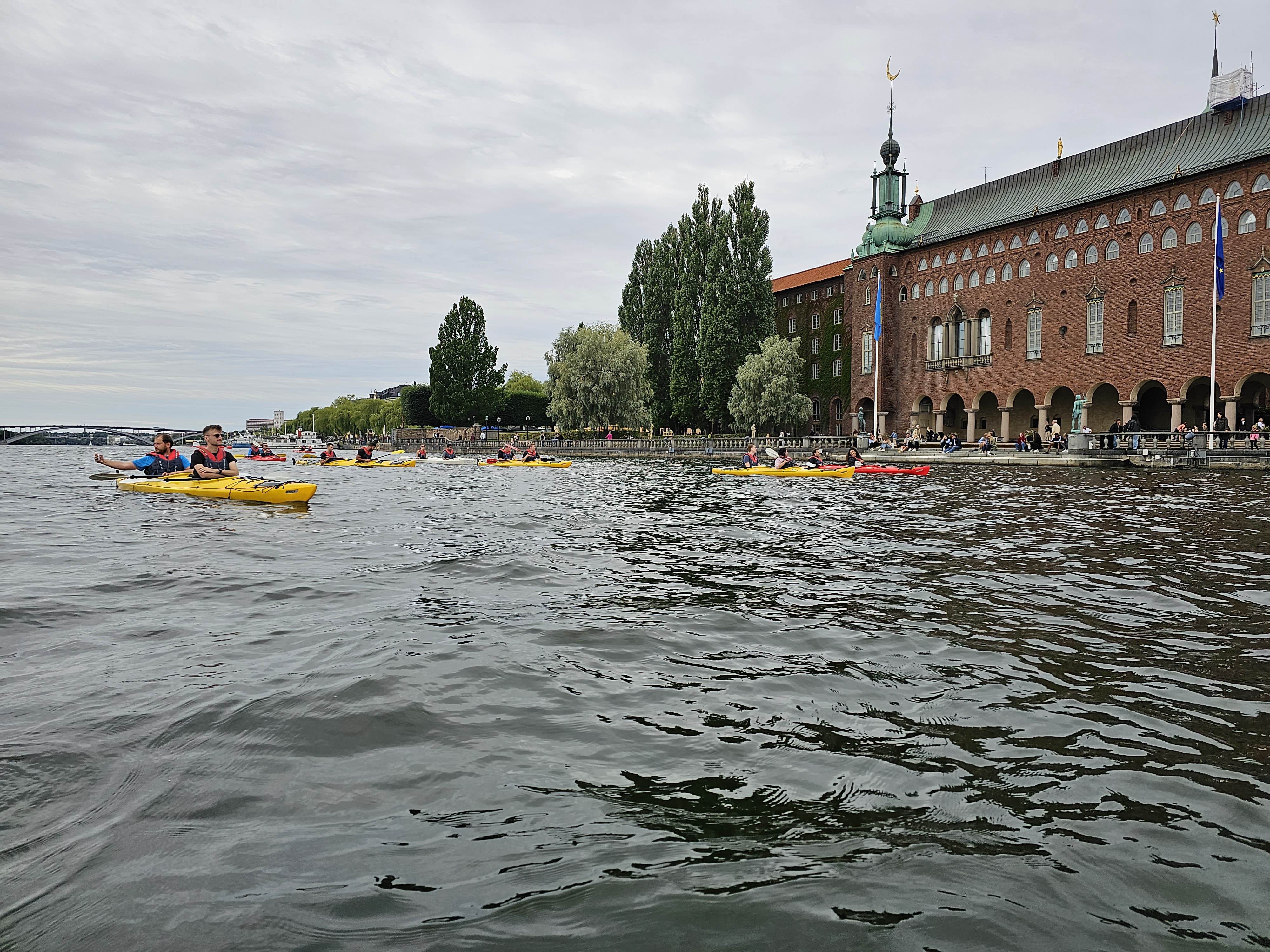 Navigating the waters with paddle in hand, basking in the view of Stockholm City Hall.